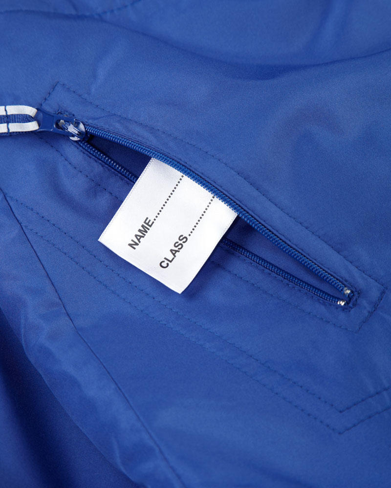 R-875B_Reversable_Kids_Jacket_Blue_Detail_Side_Pockets_And_Name_Tag